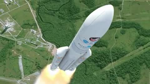 Aerial tracking shot of the Ariane 5 ascending over green terrain