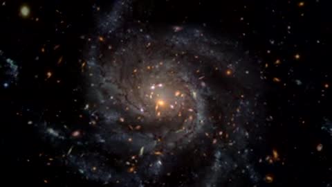 Animation sequence of a spiral galaxy appearing from a field of distant stars