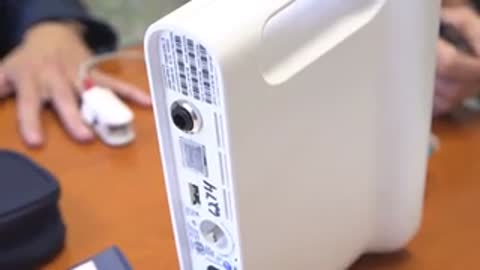 Close-up of a medical device with a finger probe on a table.