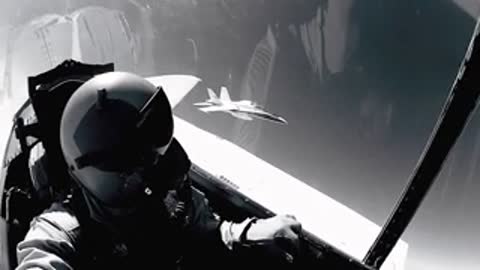 A view from inside a cockpit showing a pilot looking forward during flight.