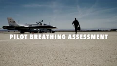 A pilot walking towards a parked fighter jet on an airfield.