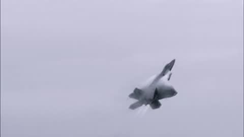 A fighter jet taking off from a runway into a cloudy sky.