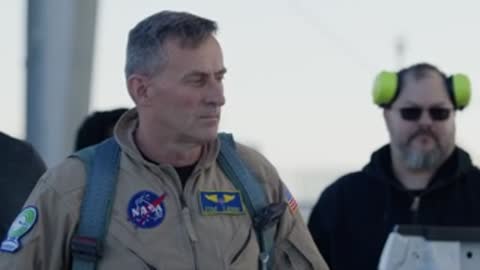 NASA test pilot standing outside in front of X-59 aircraft.