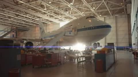 A large NASA Boeing 747 aircraft parked inside a maintenance hangar.