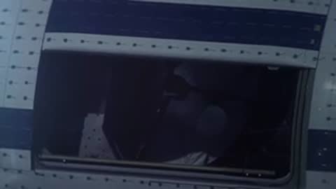 Close-up of a person looking through a specialized window on the SOFIA aircraft.