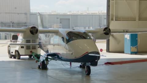 Electric propulsion aircraft sitting inside the hangar with open doors