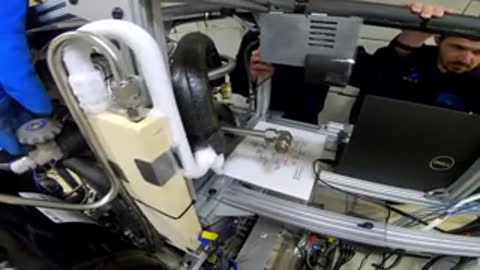 Industrial machinery equipment setup with wires and monitors inside a facility.