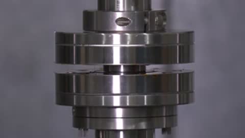 Close-up of a precision mechanical assembly separating in a test setup