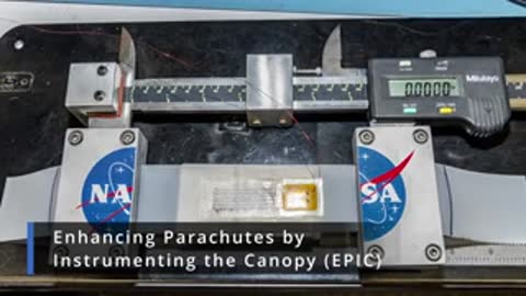 Measuring device displaying measurements on a digital screen with NASA logos