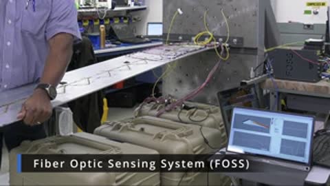 Person interacting with a test setup involving a long panel and laptop