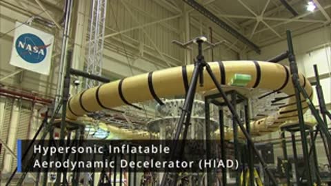 Large inflatable aerodynamic decelerator structure mounted inside a testing facility