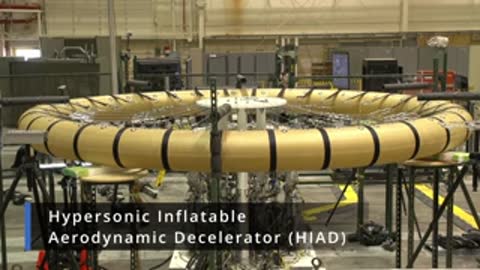 Full view of a large circular inflatable aerodynamic decelerator in a laboratory