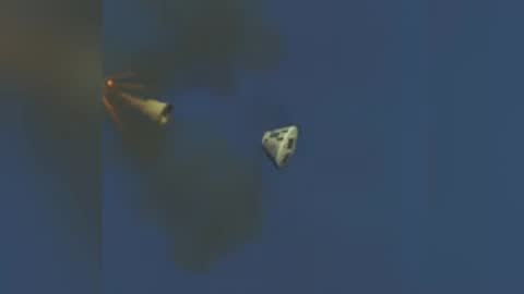 A projectile launches in flight against a clear sky background.