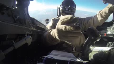 Pilot in the cockpit of an aircraft handling controls during flight.