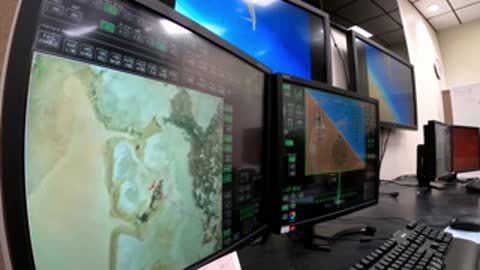 Control room with multiple monitors showing geographic maps and telemetry data.
