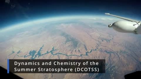 Aerial shot showing the curvature of the Earth and a landscape below from a plane.