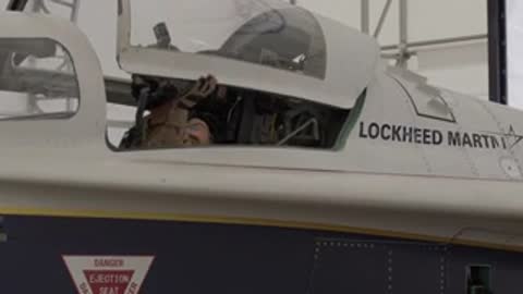 Pilot closes cockpit canopy of Lockheed Martin X-59 aircraft.