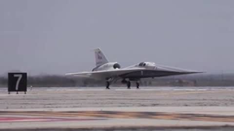 X-59 aircraft taxis past a runway sign numbered 7.