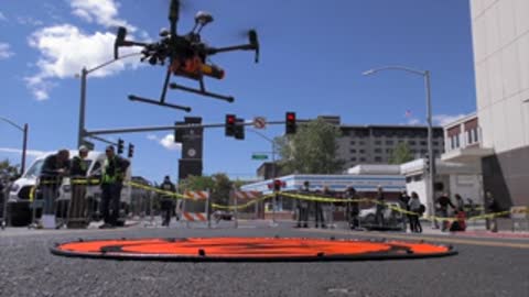 Drone taking off and landing on pad in city street.