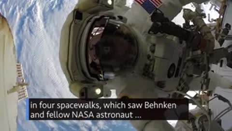 Astronaut working outside the International Space Station in a spacesuit.