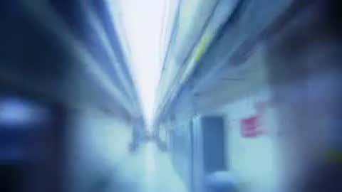 Fast tracking shot moving quickly down a narrow illuminated tunnel or hallway