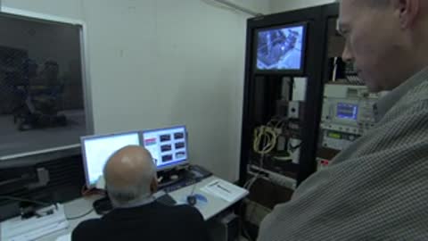 Engineers monitoring data on computer screens inside the control room