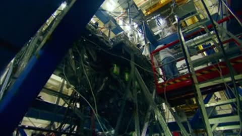 Team of technicians manually operating hydraulic pumps during a test procedure