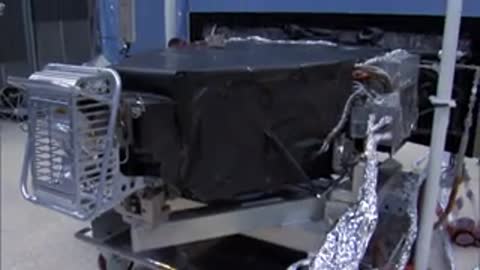 Covered hardware or equipment on a rolling cart in a lab