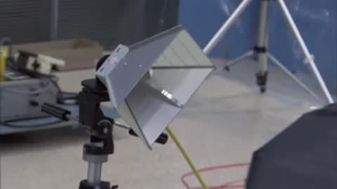 Directional antenna setup on a tripod in a testing room