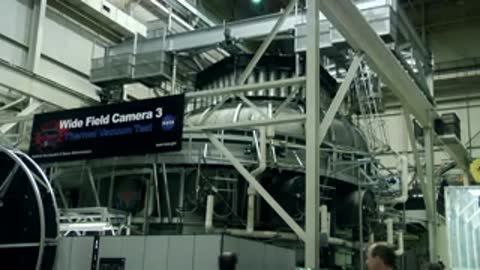 Exterior view of a large thermal vacuum chamber with testing signage
