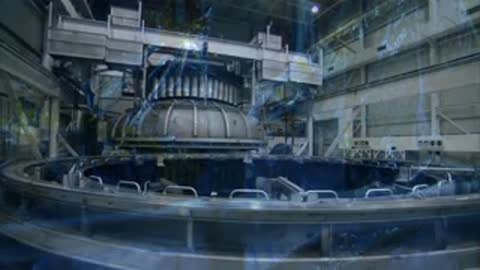 A panning view from wrapped space hardware to the massive testing facility floor.