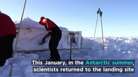 Scientists returning to landing site in Antarctica with shovels.