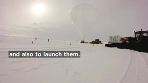 Helium-filled balloon launching over Antarctica in snowy landscape.