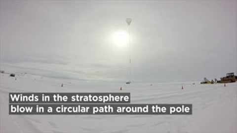Helium-filled balloon flying high in stratospheric winds over Antarctica.