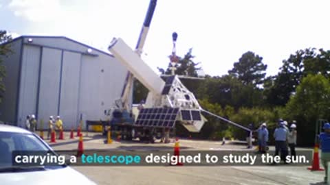 Telescope designed to study the sun mounted on a structure outside.