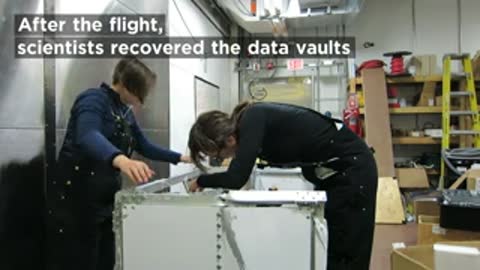 Scientists recovering data vaults inside station after the flight.