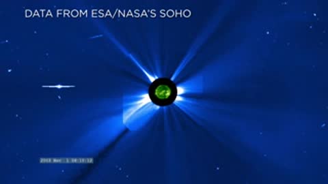 Blue space telescope imagery showing the sun behind an occulting disk from SOHO data