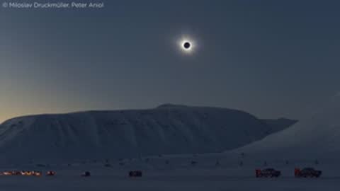 Photographic sequence of a solar eclipse seen above a dark mountainous landscape