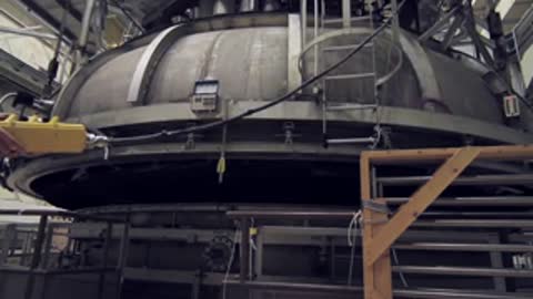 The massive industrial dome cover lifting up from the test apparatus