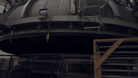 Wide view of the industrial test rig with the heavy circular lid fully raised