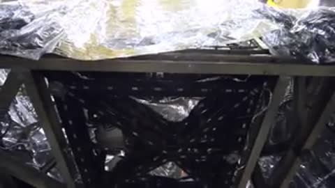 Close up angles of the heavily wrapped module frame being extracted from the pit