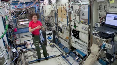 Astronaut floating in ISS laboratory module.