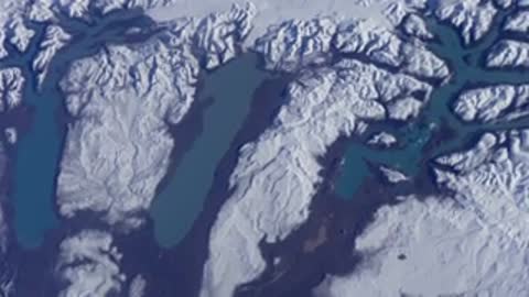 Satellite view of snow-covered mountainous terrain.