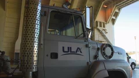 Close-up tracking shot of the ULA semi-truck cab moving forward inside a building.