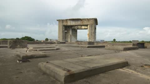 Wide shot across the top platform of Launch Complex 34 toward a distant structure