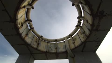 Low angle view looking up into the circular roof hatch against the sky