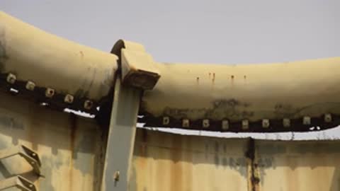 Close-up view of bolted metal brackets along the circular structure rim