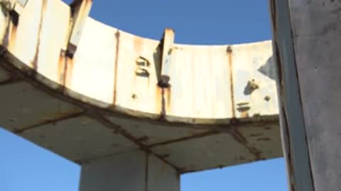 Close-up of the upper section and rim of a concrete structure.