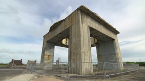 Exterior view of the Launch Complex 34 concrete structure under a cloudy sky