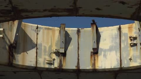 Close-up of the textured surface and brackets of a concrete structure.